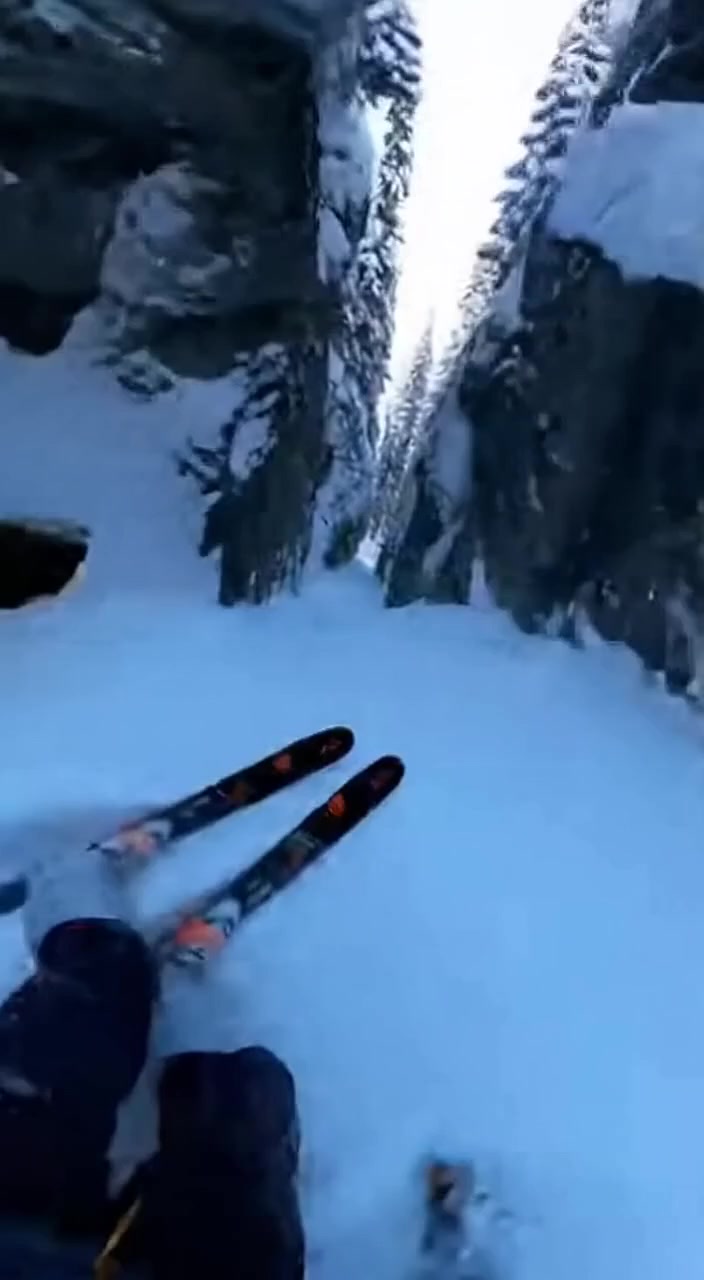 A Skier Carves a Path Through a Narrow Mountain Gorge.